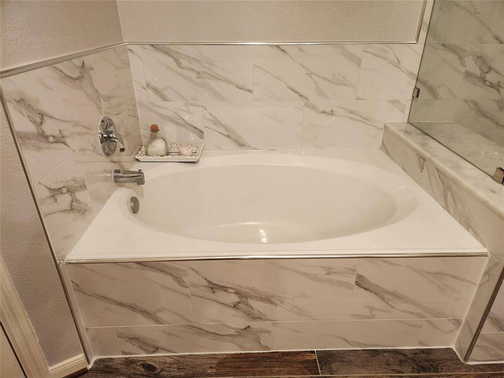 Gorgeous marble tile encased soaker tub.