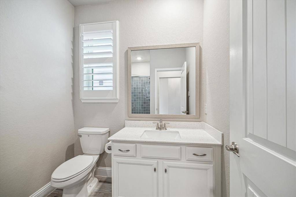 A full bathroom with a tiled shower is conveniently located near the first-floor secondary bedroom.