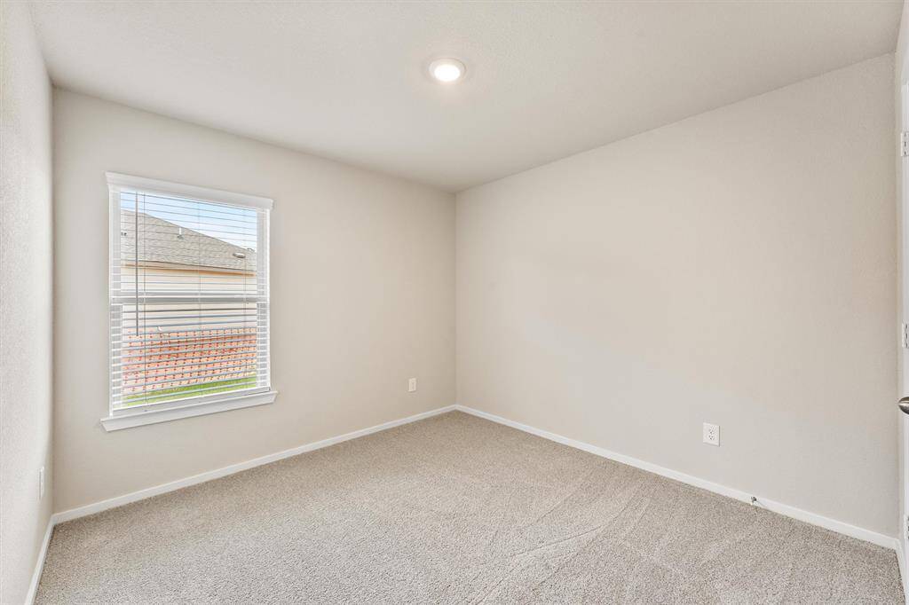 kitchen with pantry, sleek dark cabinets, stainless steel appliances, and a spacious white island