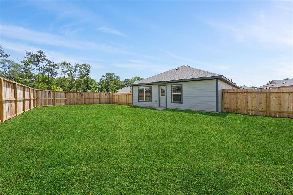 Garage with a modern automatic door opener, neutral walls, and ample lighting, ideal for parking and storage.