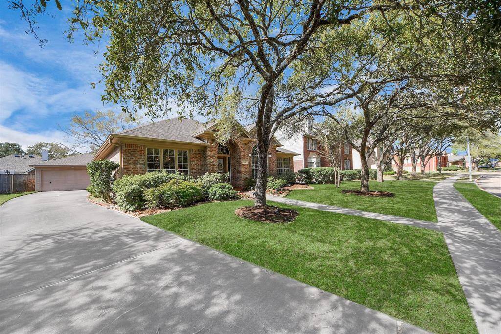 Charming brick home with a spacious driveway and lush front yard, set in a tree-lined neighborhood. Ideal for buyers seeking a serene and picturesque setting.