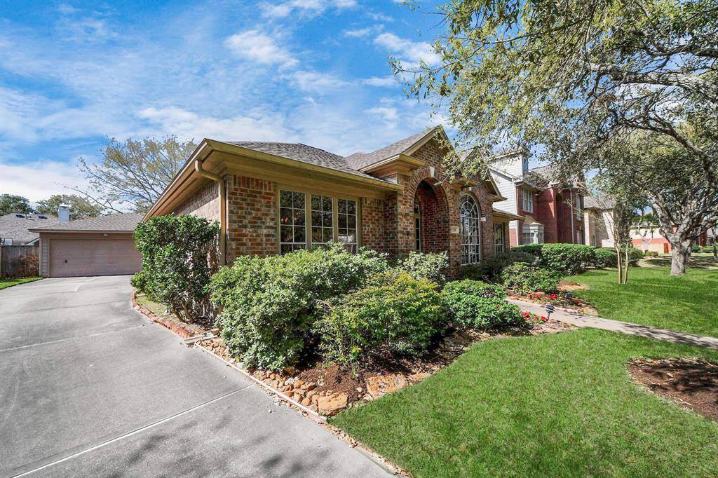 Charming brick home with a well-maintained front yard and mature trees. Features a spacious driveway leading to a detached garage. Ideal for buyers seeking a cozy, inviting exterior in a quiet neighborhood.