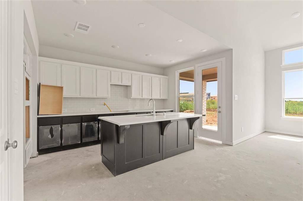 High ceilings and abundant light make this kitchen a bright centerpiece
