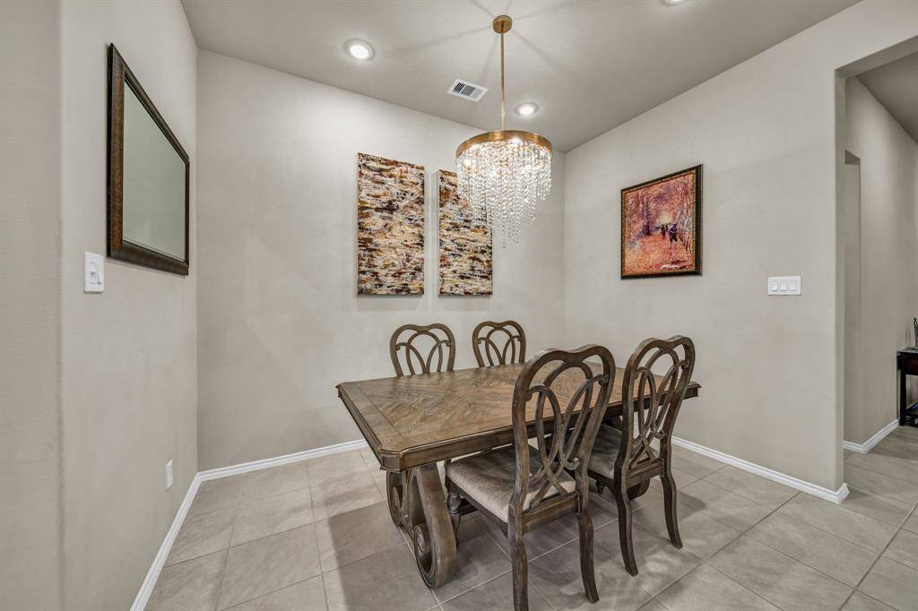 Formal dining area with modern chandelier