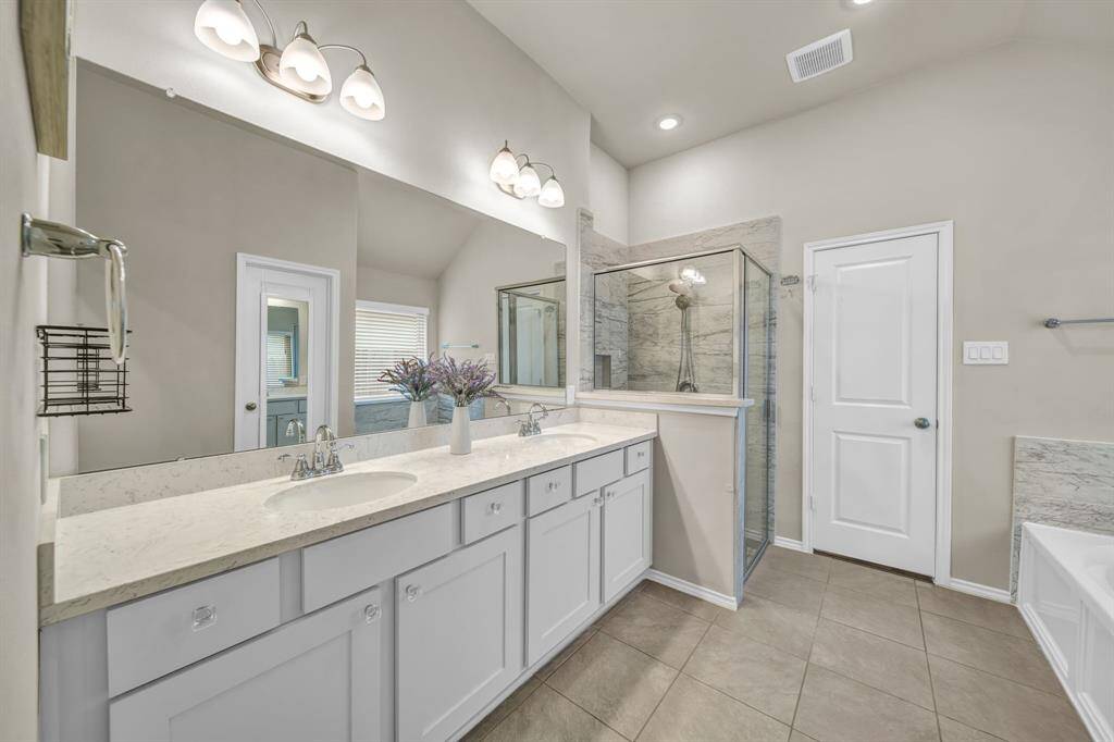 Primary bath with double sinks and walk-in shower.