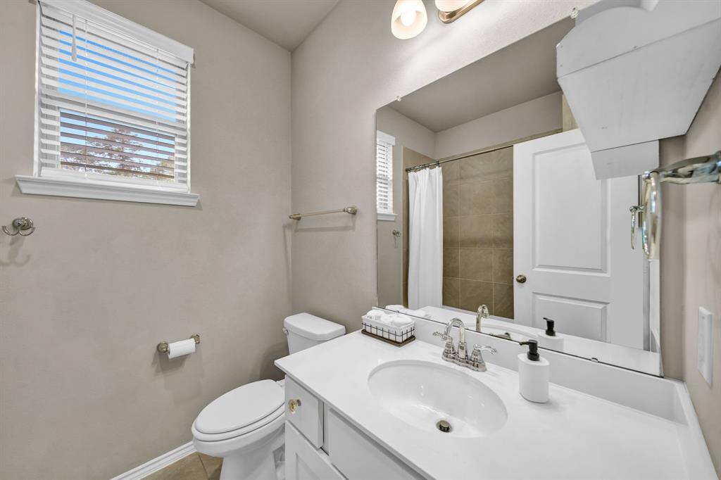 Full bathroom with tub/shower combo and modern fixtures.
