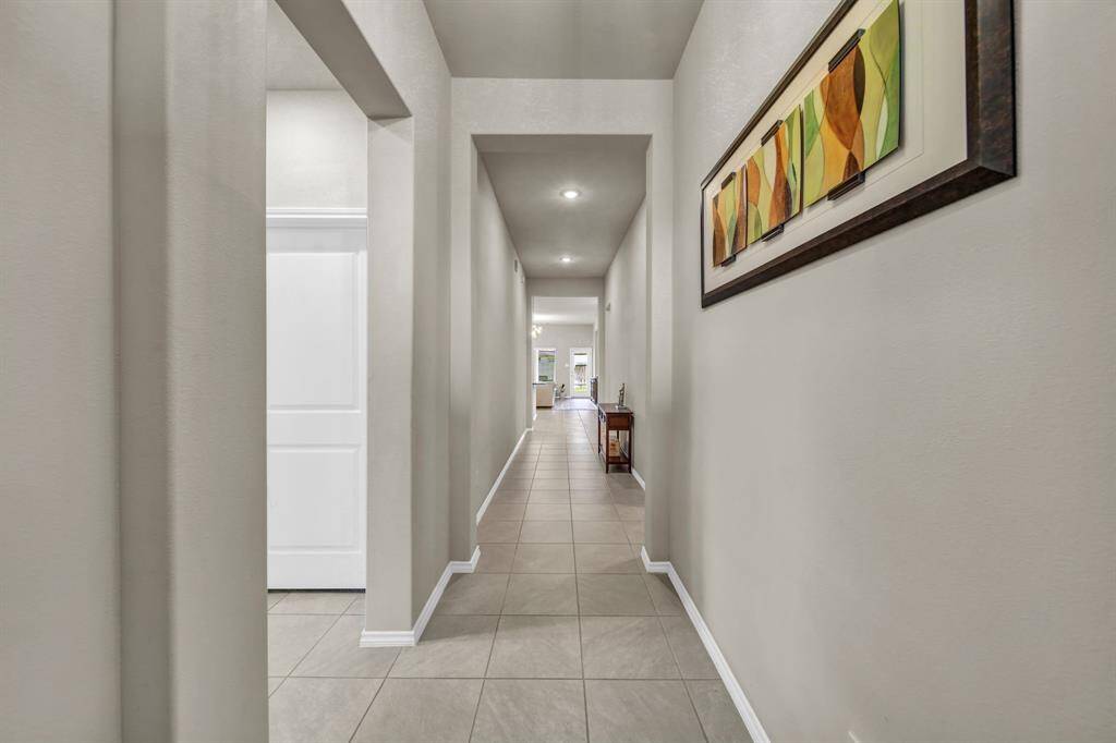 Long entry hallway leading to the main living area.