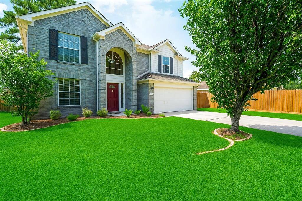 This beautiful two-story home features a charming brick and siding exterior, manicured landscaping, a welcoming front porch, and a spacious driveway leading to a two-car garage. Large lot with side yard!!