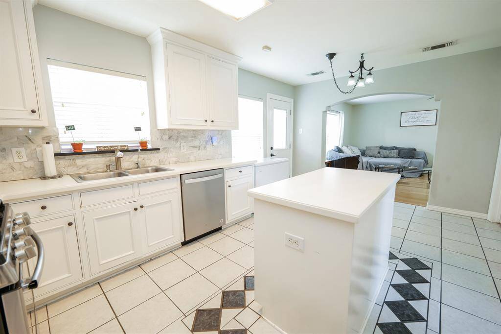 The spacious kitchen island offers additional counter space, and storage, making it a perfect centerpiece for meal prep and casual gatherings.