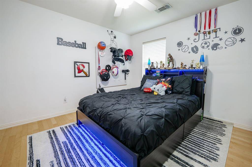 The oversized secondary bedroom offers generous space, large windows for natural light, and flexibility for various furniture layouts or uses.