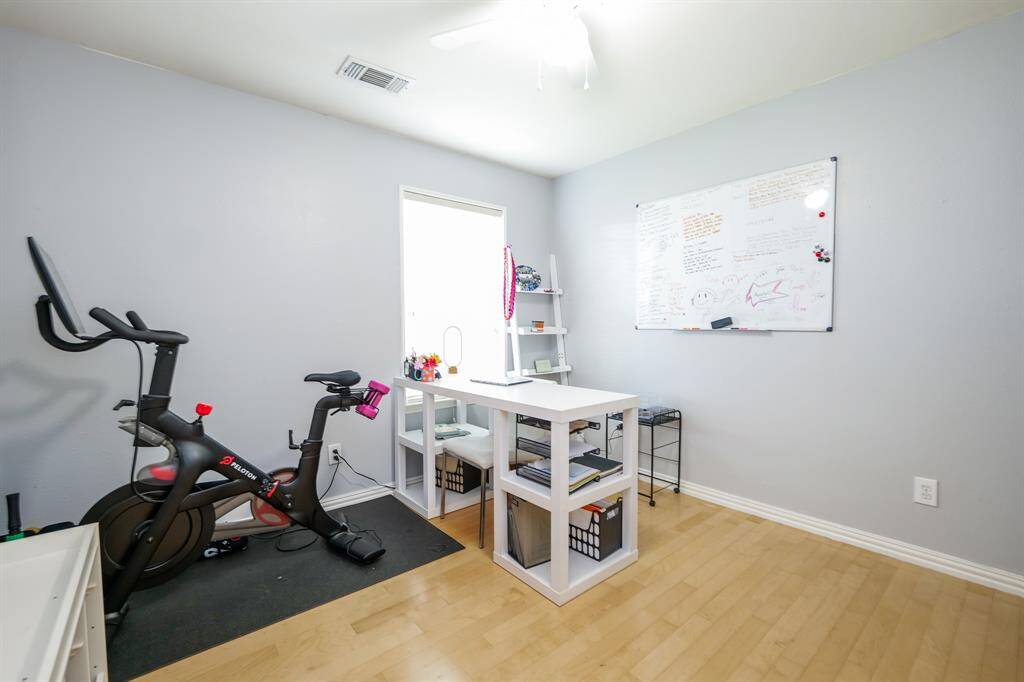 The oversized secondary bedroom is currently utilized as a versatile home office and gym, offering ample space and flexibility to suit your lifestyle needs.
