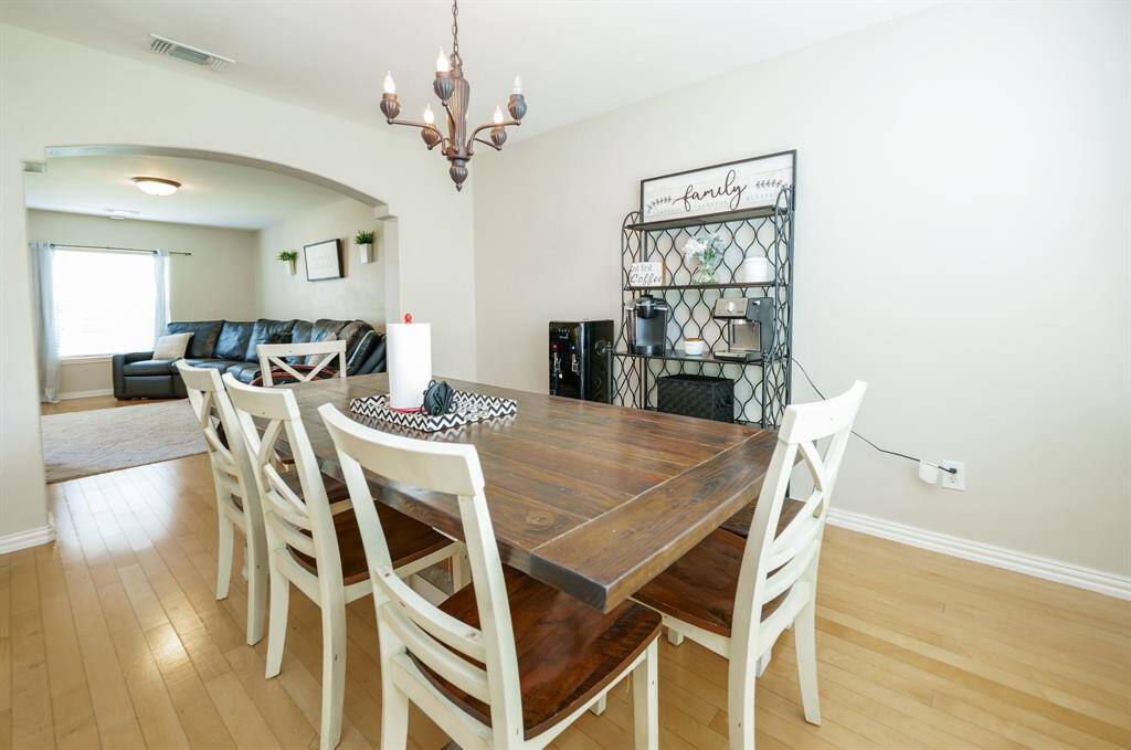 The elegant dining room features ample natural light and a stylish layout perfect for hosting gatherings and family meals.