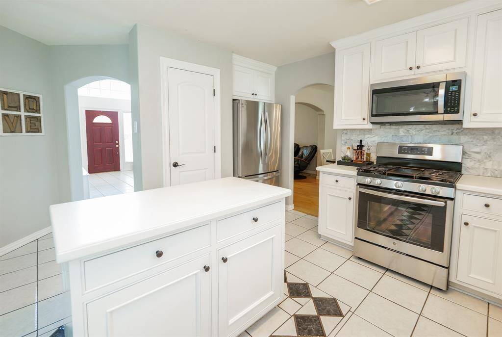 The kitchen features modern appliances, ample cabinet space, and a convenient layout perfect for everyday cooking and entertaining.