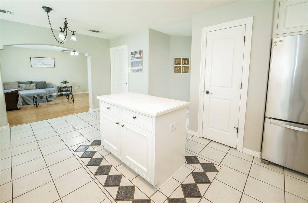 The kitchen opens into a cozy secondary living room, creating a seamless flow for comfortable living and easy entertaining.