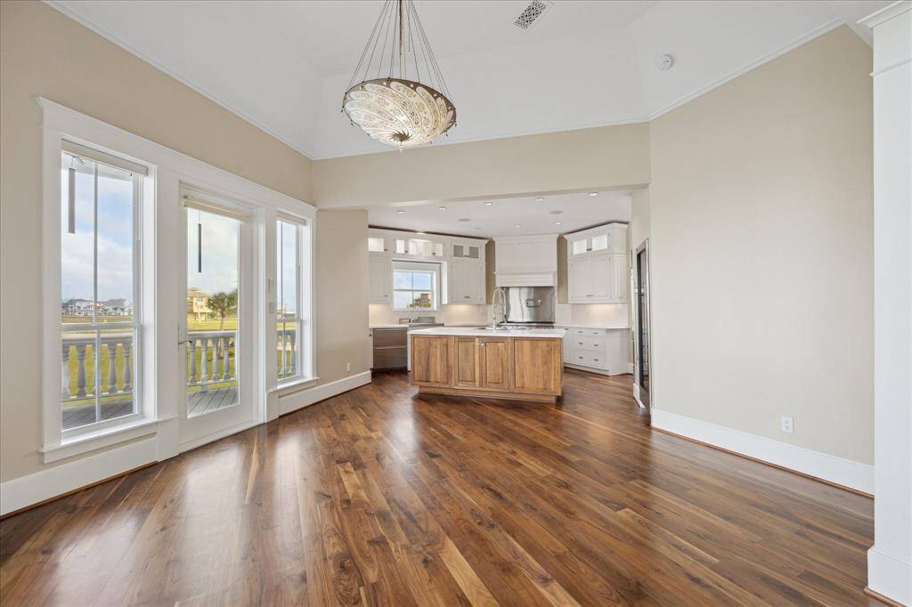 The dining room flows seamlessly into the great room and kitchen, creating an ideal layout for effortless entertaining. Walls of windows surround the space, offering panoramic waterfront views from every angle and setting the stage for a serene and memorable dining experience