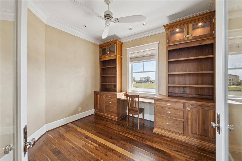 The study offers built-in shelving & desk, creating a refined and functional workspace—all set against the backdrop of breathtaking waterfront views