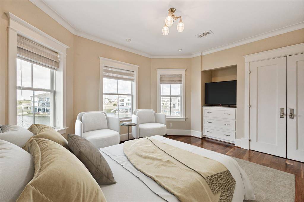 The third level features three bedrooms, connected by an open interior balcony that overlooks the great room. Elevator access is available to all floors for convenience