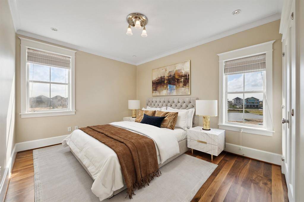 The second guest room is spacious and features waterfront windows, creating a relaxing ambiance that your guests will truly appreciate