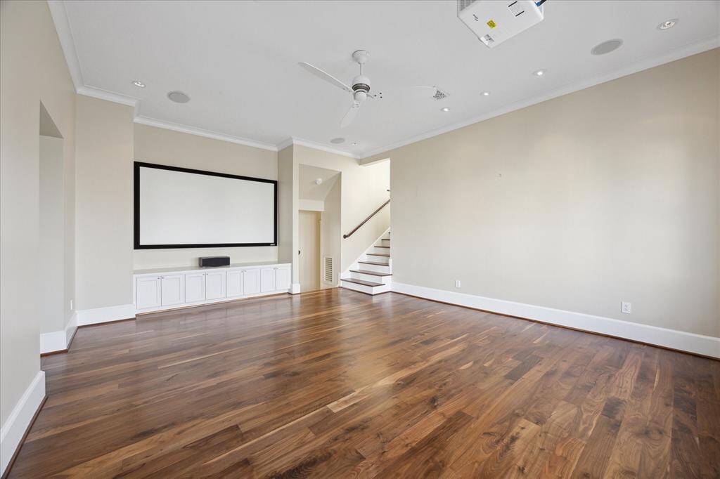 The media room, equipped with a movie screen and surround sound system, is perfect for watching the game or a movie. Spacious enough for the whole family, it also offers waterfront views