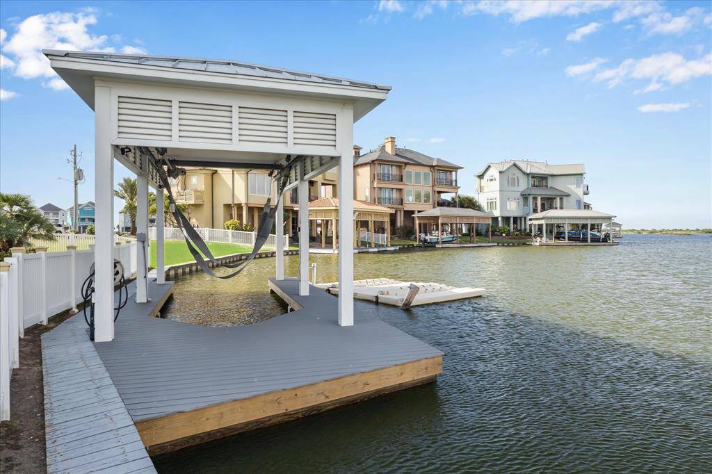 A stone pathway guides you to the boathouse, complete with a 6,000 lb lift and a sun deck perfect for soaking up the rays. A convenient swim ladder offers easy access in and out of the water when needed
