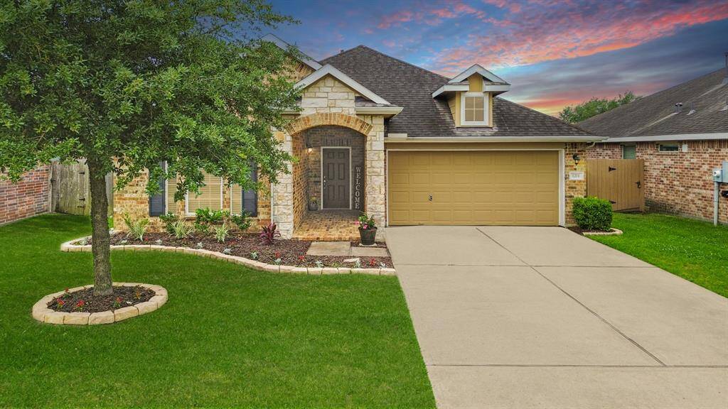 This beautiful one-story home surrounded by stone-lined flower beds features a brick exterior highlighted by decorative shutters & stone accents. Updates include new interior paint, a whole home water softening system & hardwood tile floors throughout the home.