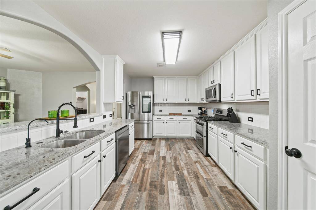 Included is an abundance of counter, cabinet & drawer storage along with a pantry.