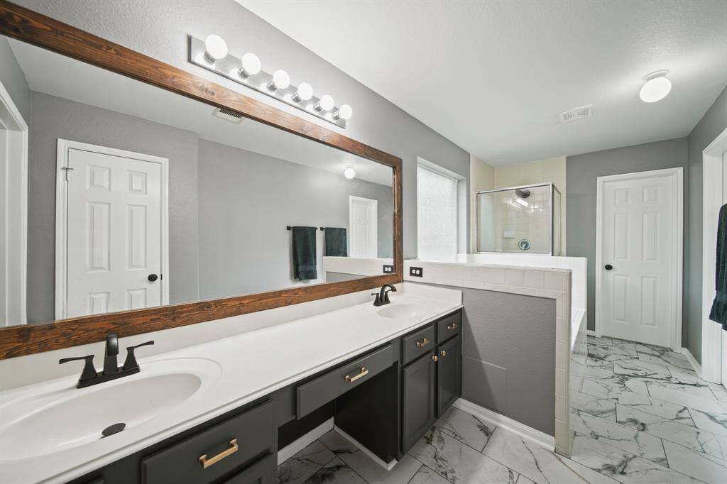 Plenty of counter & storage space is included along with a framed mirroe, make-up vanity area.