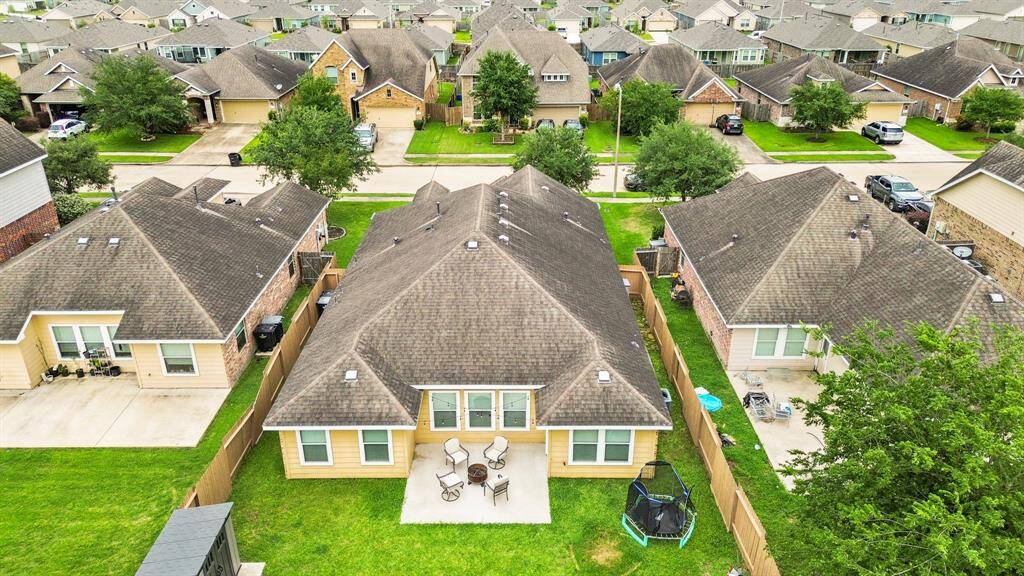 An aerial view of the home, fence lines, patio & backyard.