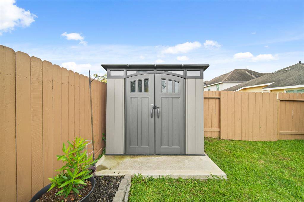 Included is an 8' x 5' storage building installed on a concrete slab in 2023. An additional smaller storage unit is accessible from the side yard.