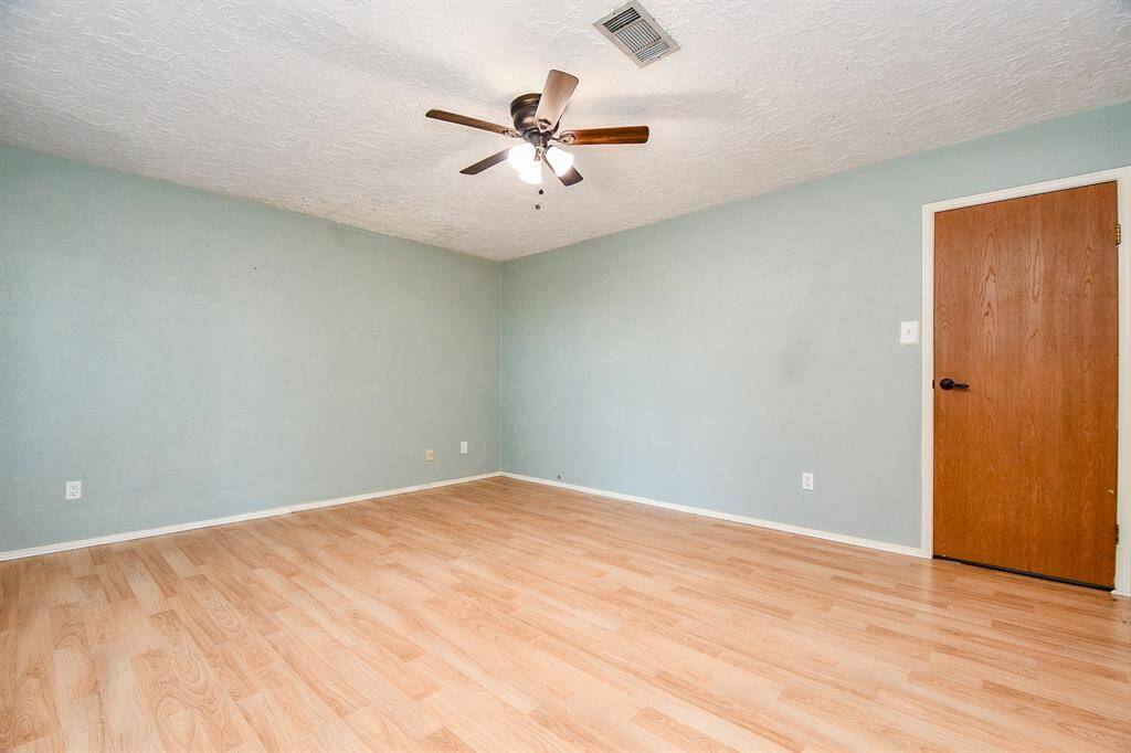 This large primary bedroom with easy access to the indoor and outdoor living areas.