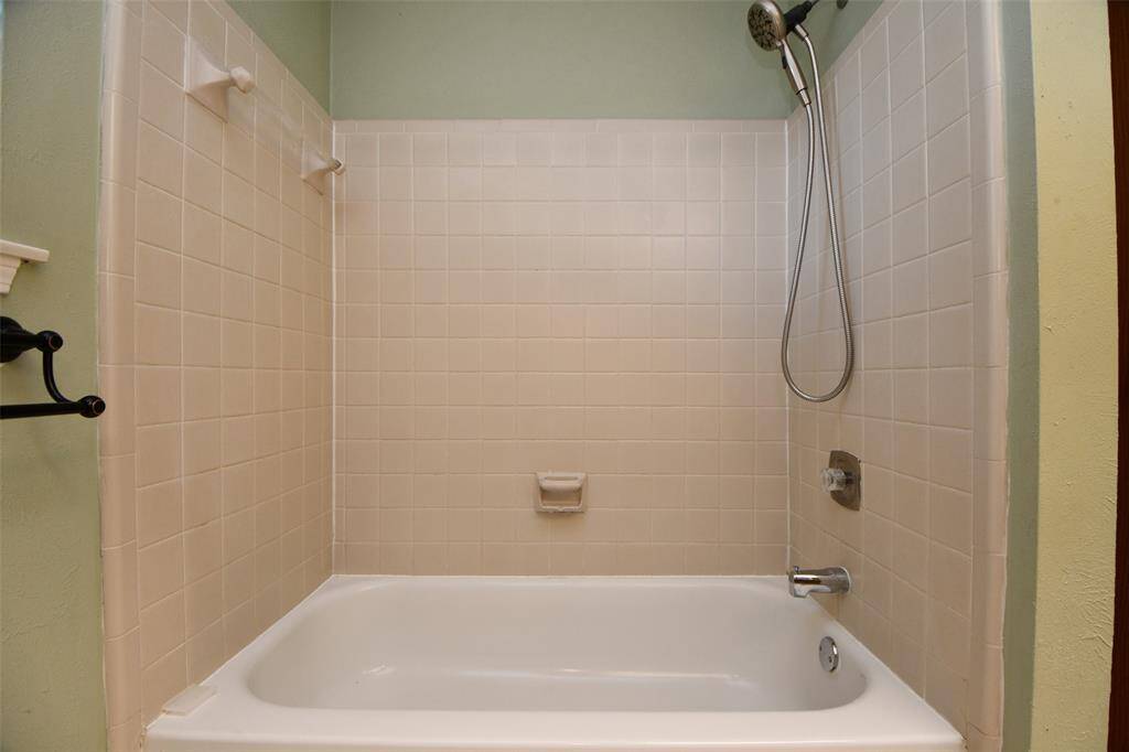 Large soaking tub in the primary shower area.