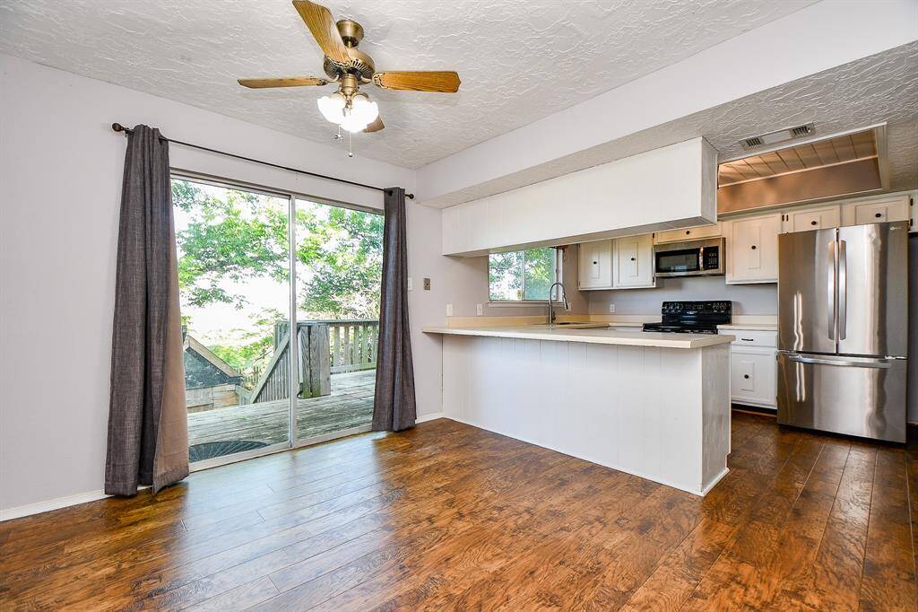 Upstairs you'll also find the open area to the kitchen with access to the backyard.