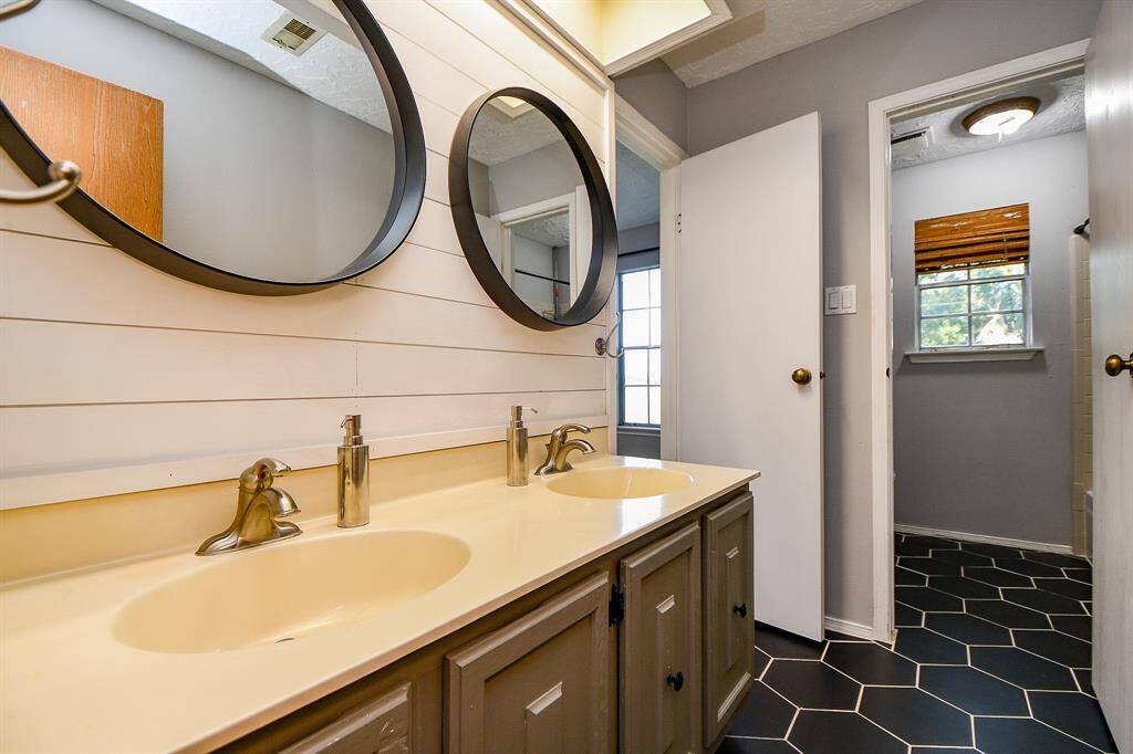 Modern upgrades welcome you in the inviting secondary bathroom, complete with two sinks!