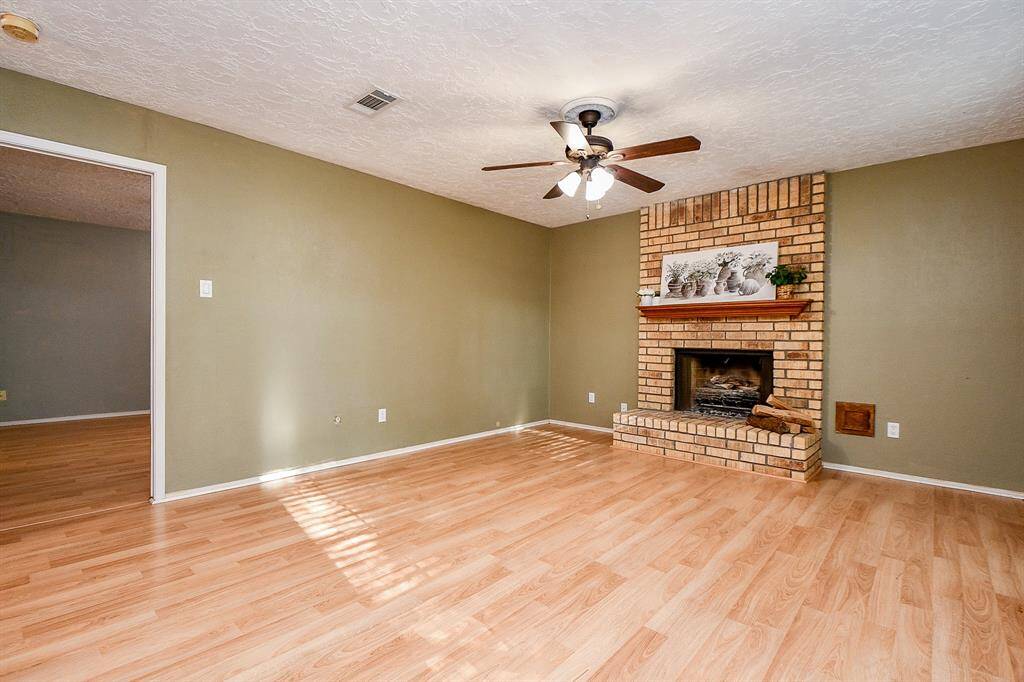 Large first floor family room with gas and wood fireplace.