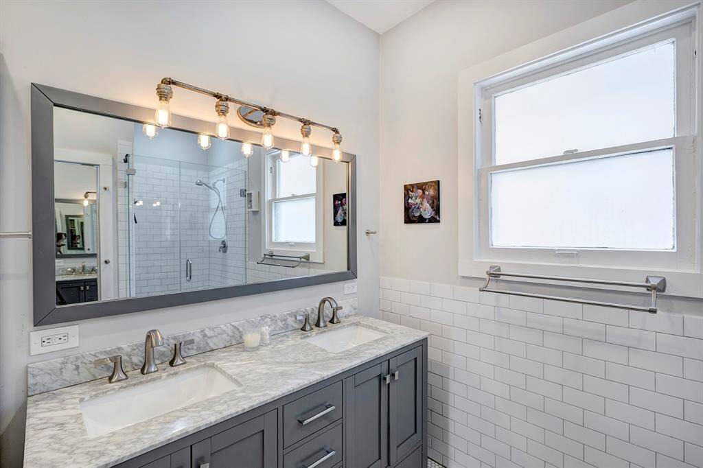 Exquisite vanity with cool light fixture and full length mirror over the double sinks.