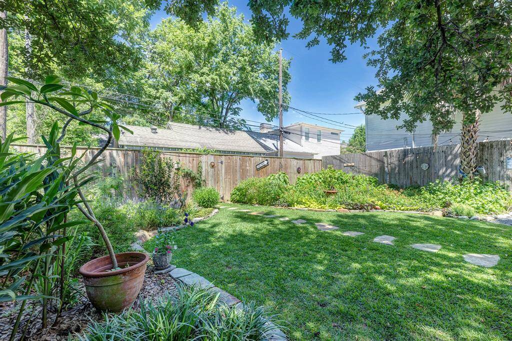 Lush landscaping abounds in this magazine worthy backyard.