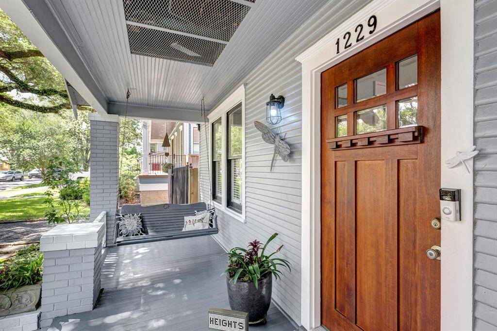 Quintessential Heights front porch is a wonderful location to greet neighbors passing by.