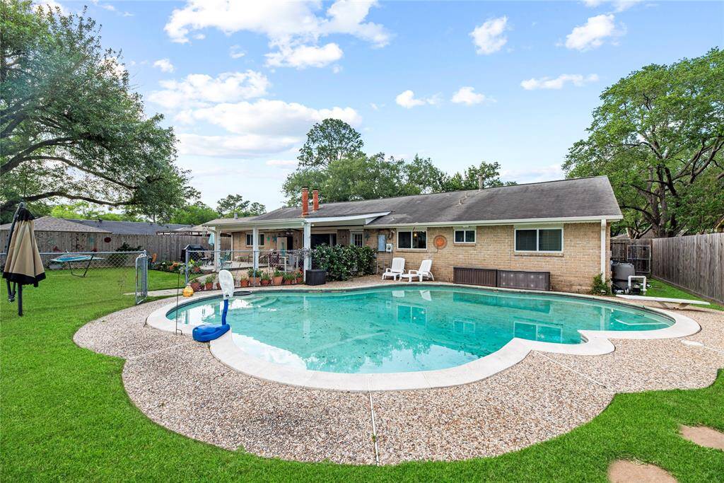 Swimming pool with surrounding fence.