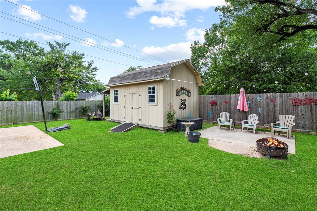 One of two storage sheds and an additional patio area.