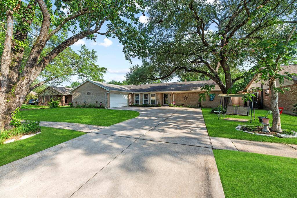 Majestic oak trees provide plenty of shade and gorgeous curb appeal.
