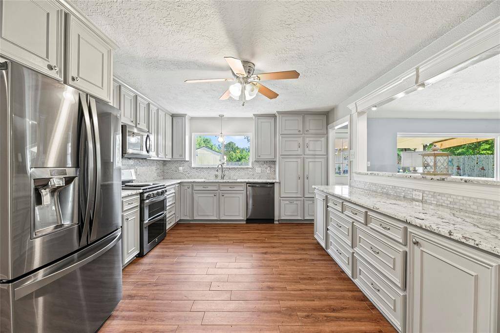 Gorgeous granite countertops, tile backsplash, stainless steel appliances, gas range and tons of storage!