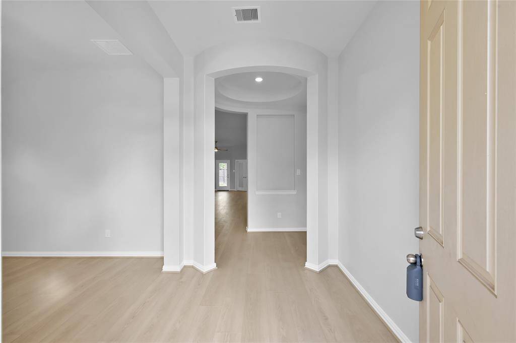 As you enter the home, you're welcomed by a view of the formal dining room or second living space, beautifully complemented by an upgraded rotunda that adds warmth and elegance to the entryway.