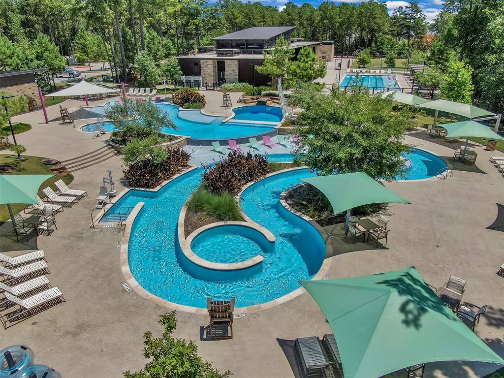 Seasonal resort-style pool features a beach entry area, lazy river with tubes, diving rock, and a fun mountain climbing wall—offering something for everyone to enjoy.