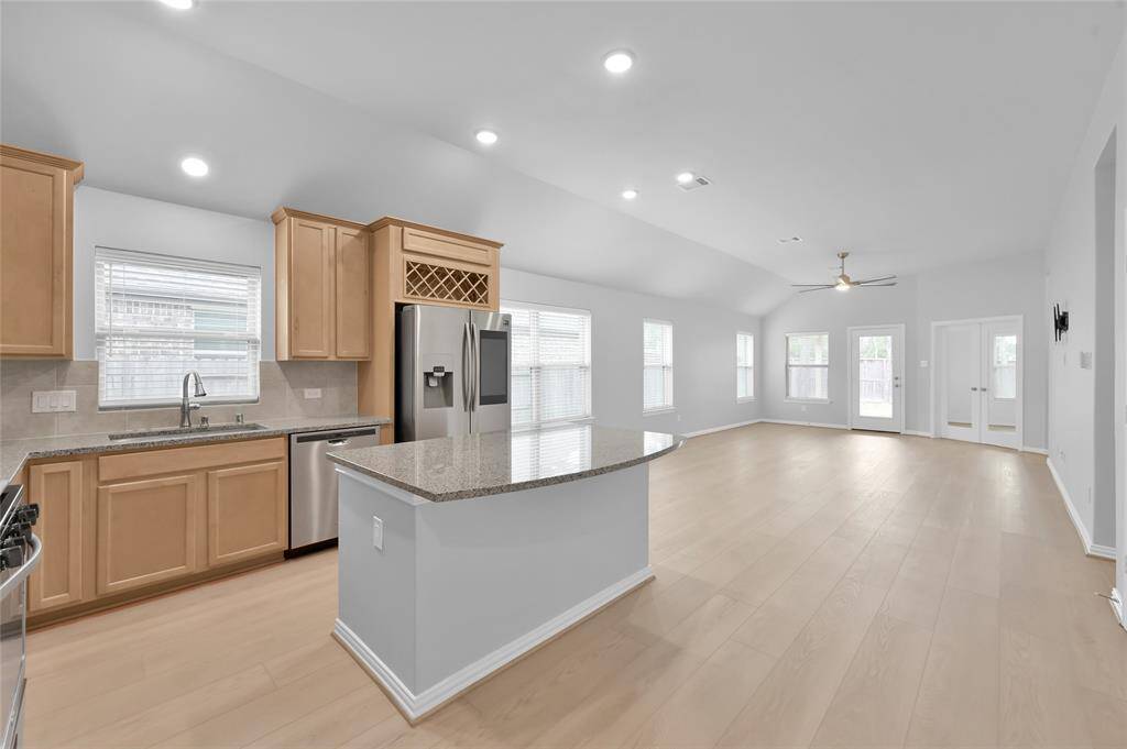 The kitchen seamlessly opens up to the family room, creating a spacious and connected layout ideal for entertaining and everyday living.