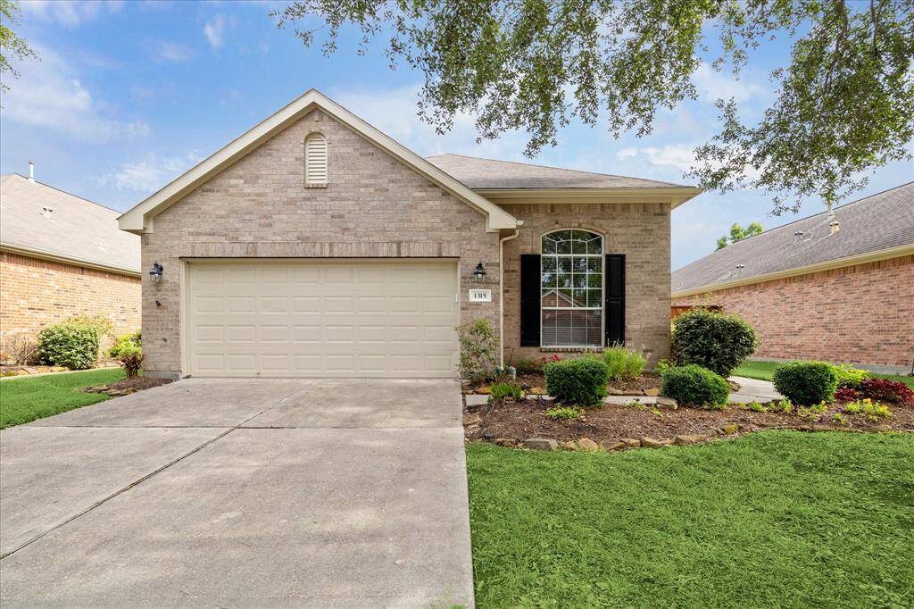 Lovely tree shaded landscaping welcomes you home in the pretty BellaVita bungalow.
