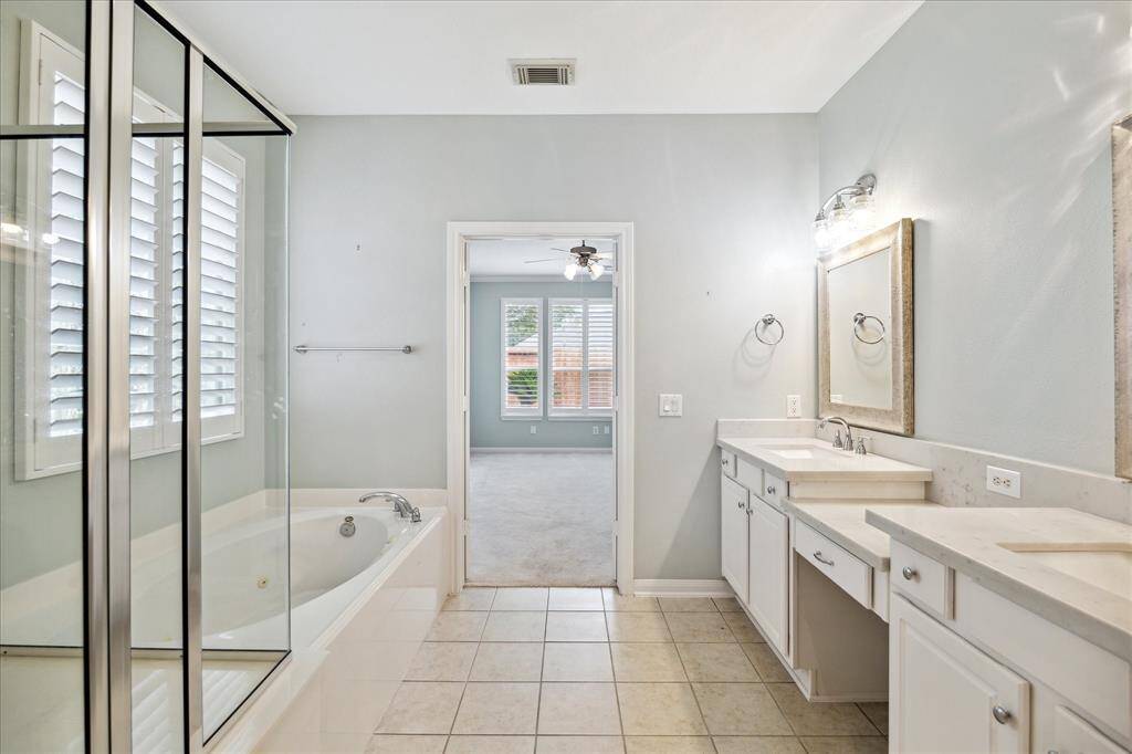 Light fixtures and mirrors have been updated. Door in rear left leads to toilet room and door on right leads to x-large walk-in closet.