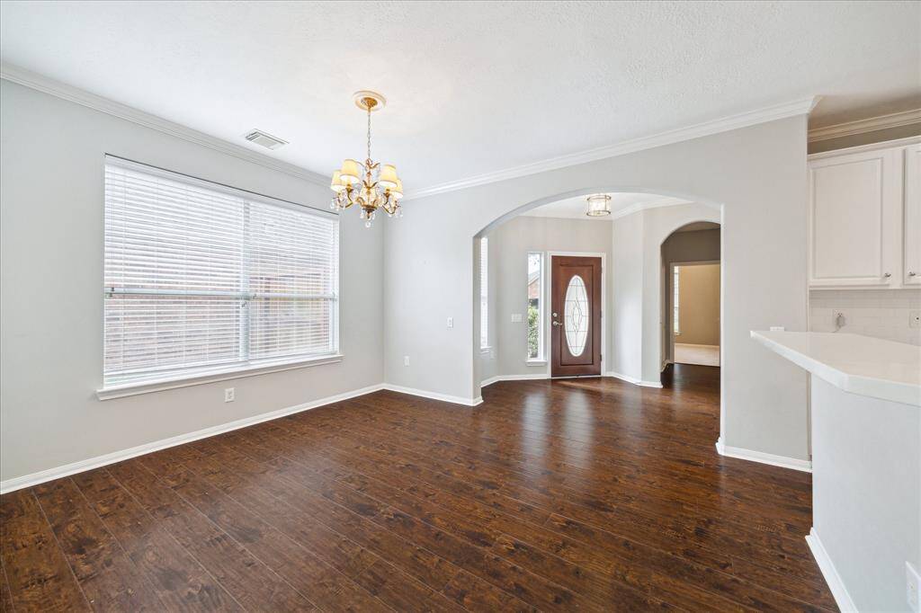 Enter the spacious Kitchen with quartz countertops and wrap-around breakfast bar that opens to the Den.