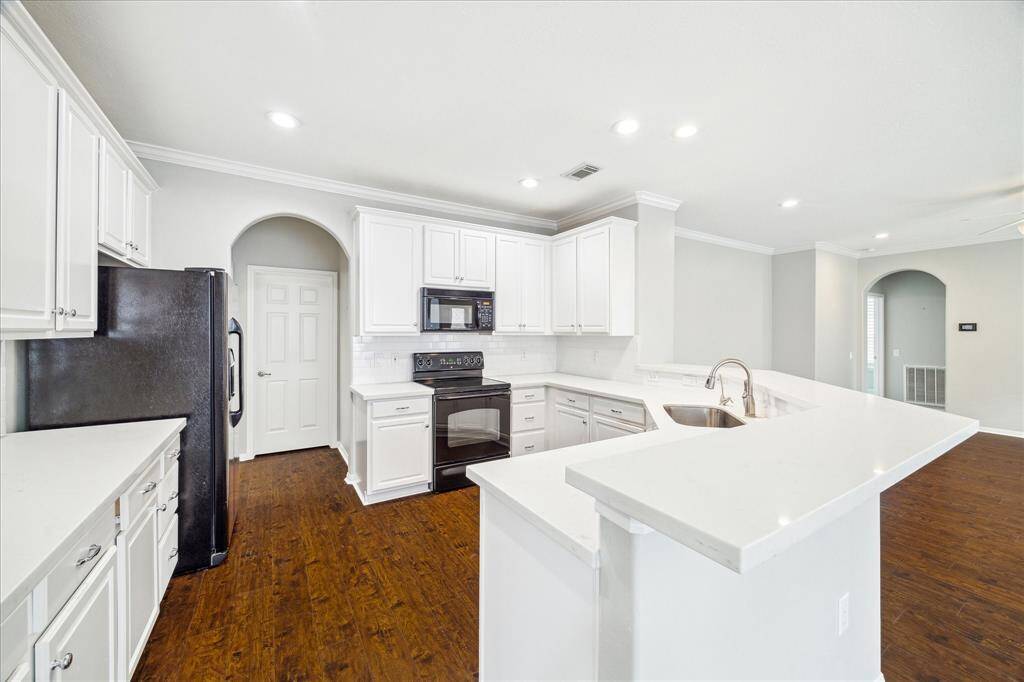 View from Kitchen into the Den at left and the Dining area at right.
