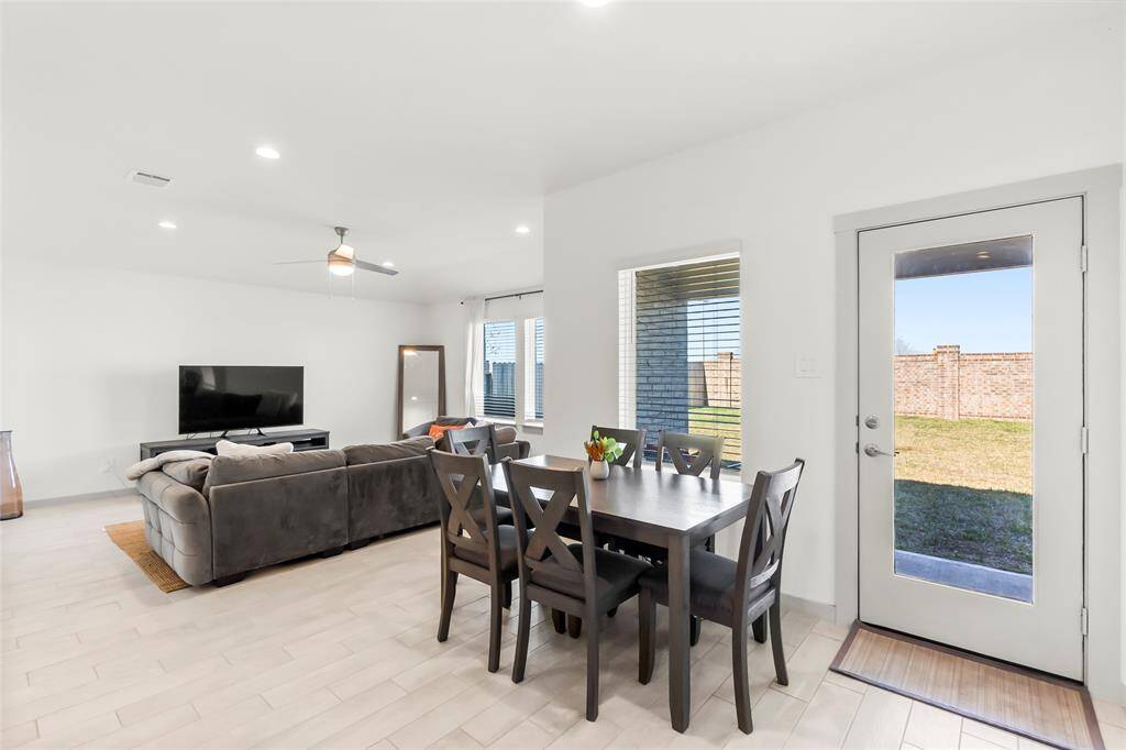 Breakfast nook with window and glass panel door for natural lighting