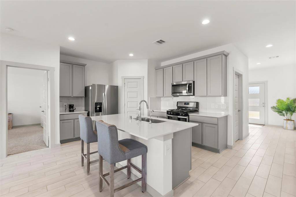 Open kitchen with coffee bar, stainless steel appliances, Island seating